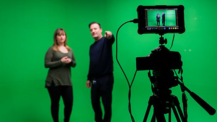 A Ƶ student being briefed in front of a green screen